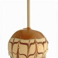 Tiger Butter Apple · Caramel-covering granny smith apple dipped tiger butter(peanut butter and white confection) ...