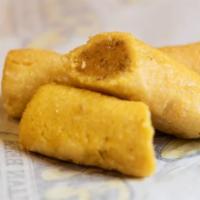 Tamale · Tasty blend of enriched cornmeal, ground beef, garlic, and seven secret spices all rolled in...