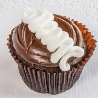 Chocolate Cream  Cupcake · Chocolate cake filled with buttercream topped with our signature fudge frosting with a dollo...