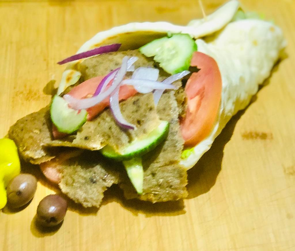 Lamb and Beef Gyro. · Cucumber, Tomato, Red Onion and Tzatziki Sauce Wrapped in Greek Pita.