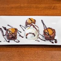 Lower Bucky Brownie Alamode · Baked brownie with peanut butter and vanilla ice cream.