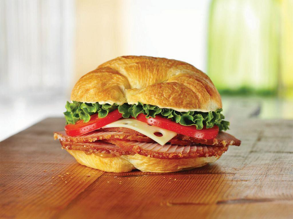 Ham Classic Sandwich · Honey Baked Ham topped with Swiss cheese, lettuce, tomato, Duke’s® mayonnaise, and hickory honey mustard on a flaky croissant. 630 cal.