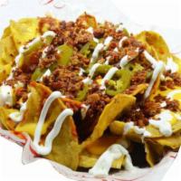 Madd Nachos · Nachos topped with chili, aged cheddar cheese, bacon bits, sour cream and jalapenos.