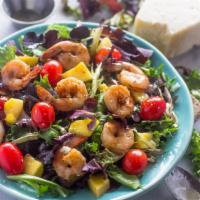 Shrimp Cajun-Mango Salad Bowl · Cajun flavored shrimp, peppers, onions, on a bed of fresh green salad and drizzled with mang...