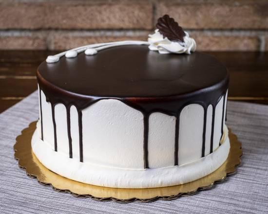 Shadow Cake · 2 layers of vanilla cake with one layer of chocolate cake, filled with chocolate buttercream frosted with vanilla buttercream and covered in chocolate icing.