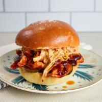 BBQ Chicken Sandwich · Pulled 38 North chicken breast in our house BBQ sauce. Served on a soft bun with adobo cole ...