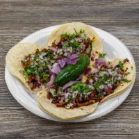 Pastor Tacos · Pork strips marinated in our own homemade Guajillo sauce, then grilled and topped with fresh...
