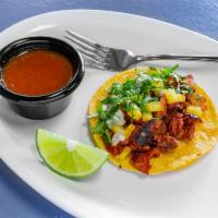 Al Pastor Taco · 1 piece. Marinated pork on a corn tortilla with onions, cilantro, pineapple, and homemade sa...