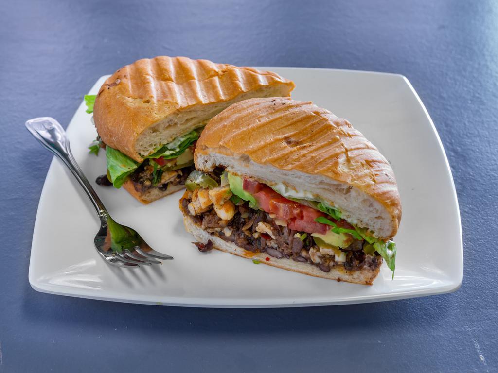 Torta · Comes on bolillo bread with mayonnaise, beans, cheese, onions, cilantro, pickled jalapeno, tomato, and lettuce.