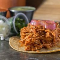 Tinga Taco · Shredded chicken marinated in a tomato chipotle sauce.