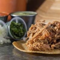 Carnitas Taco · Slow cooked pork carnitas topped with onions and cilantro. Salsa verde recommended.