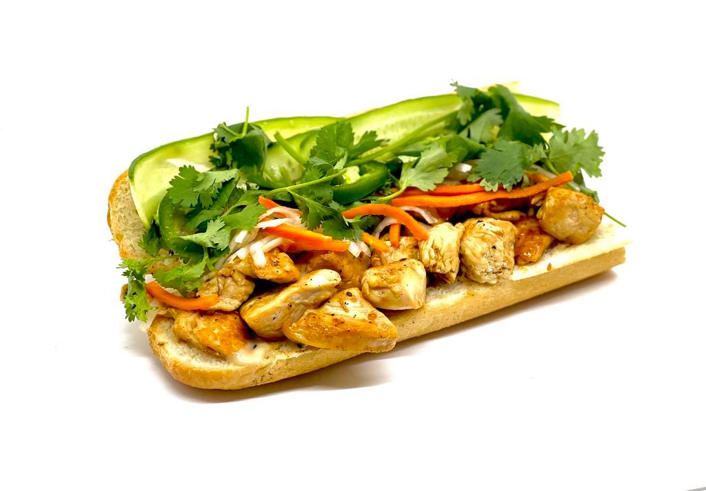 Garlic Pepper Chicken Banh Mi · marinated garlic chicken on a toasted french baguette with pickled daikon & carrots, fresh mint, cilantro, cucumbers, sliced jalapeno & sesame aioli