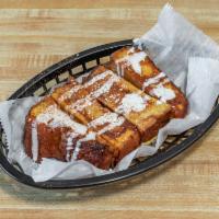 French Toast Stix · 8 pieces of our cinnamon swirl French toast, drizzled with vanilla buttercream, dusted with ...