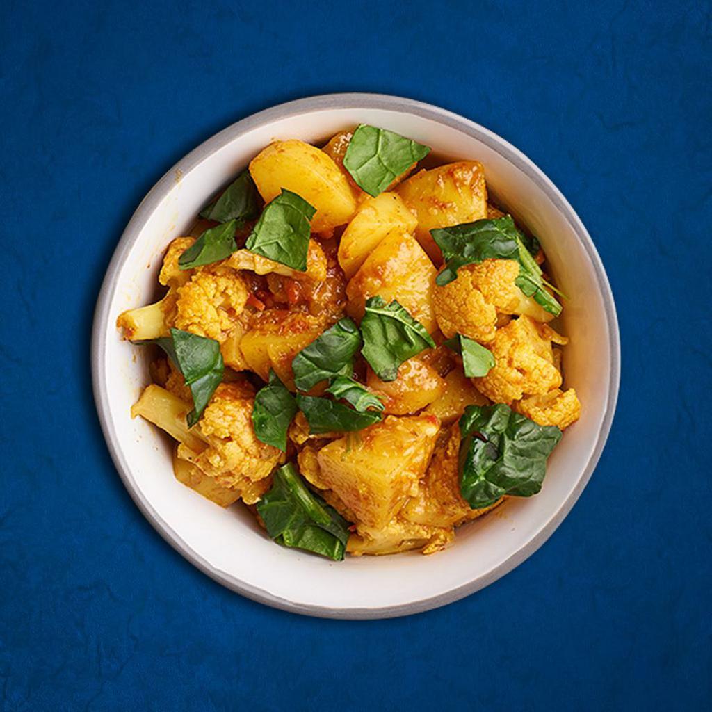 Savory Potato Cauliflower(Vegan) · House spiced fresh cauliflower and potatoes cooked slowly in a curry sauce with herbs and spices served with a side of aromatic basmati rice

