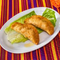 Pastelitos Dominicanos · Fried and stuffed turnover.