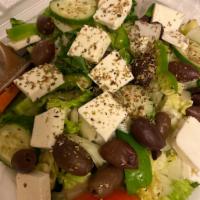 Greek Salad · Iceberg lettuce topped with feta cheese, Kalamata Olives, onions, tomatoes, and green pepper...