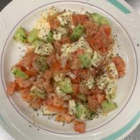 Traditional Greek Salad · Diced tomatoes, cucumbers and onions tossed with feta cheese and extra virgin olive oil spri...