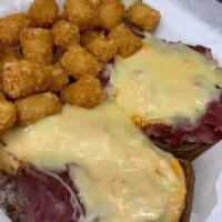 Reuben Sandwich · Thinly sliced corned beef served open faced on marble rye with sauerkraut and 1000 Island dr...