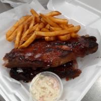 Full Slab of Babyback BBQ Ribs · Topped with a tangy BBQ sauce.