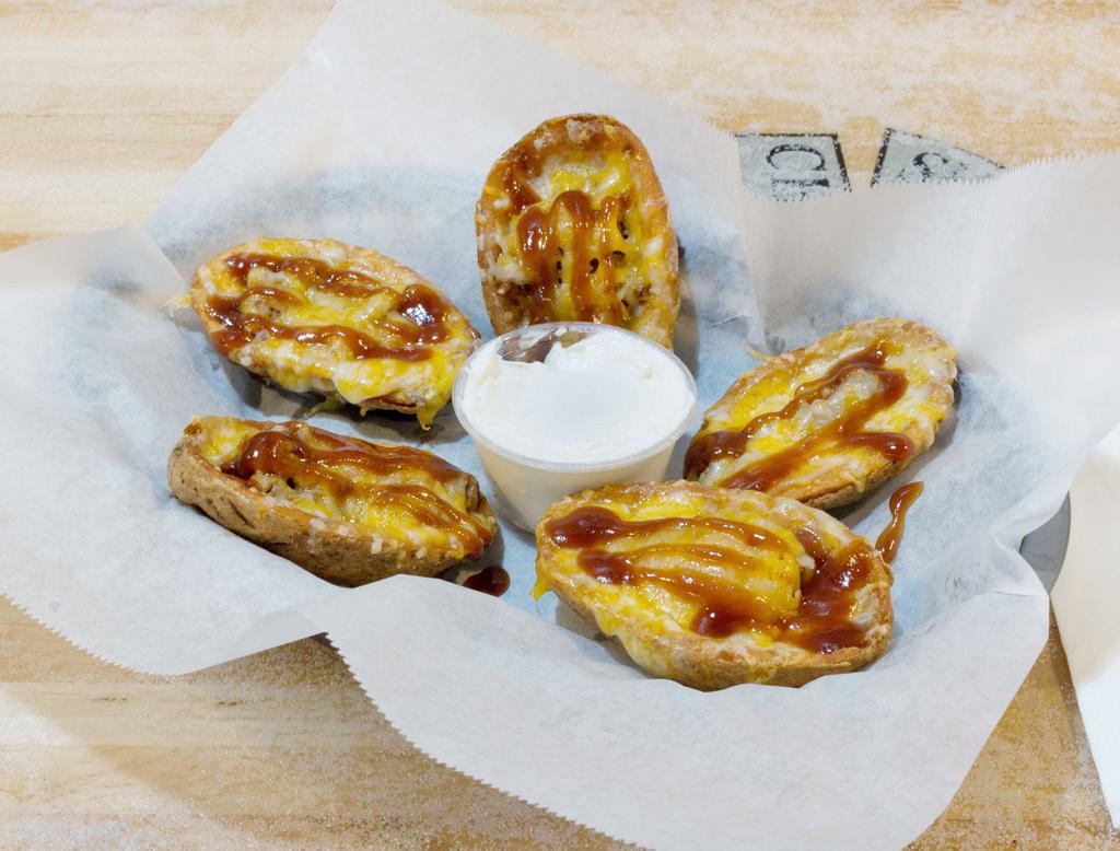 Pig Skins · 5 potato skins filled with BBQ pork topped with cheese served with a side of sour cream.