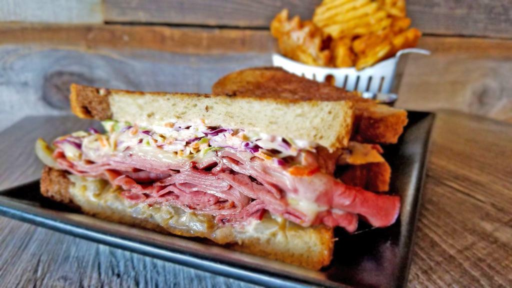 Pastrami Reuben Sandwich · pastrami • swiss • grilled onion •
coleslaw • thousand island • grilled on
rye bread