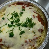 Chicken Parmigiana · 2 breaded chicken breast smothered in provolone and our house made marinara served over spag...