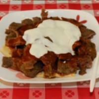 Turkish Lamb Doner · Halal rotisserie lamb sliced and marinated in yogurt and mild spices served on top of choppe...