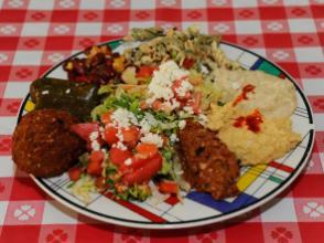 Mediterranean Platter · A sampler plate consisting of hummus, babaganush, tabouli, Mediterranean salad, dolmas, ezme, 3 bean salad, a falafel and choice of either fruit or pasta salad. Served with pita bread and a side of tzaiki.
