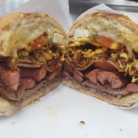 Cubana Torta · ALL TORTAS COME WITH BEANS, MAYO, AVOCADO, ONIONS, AND TOMATOES. 

Breaded beef, sausage, ch...