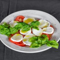 Caprese · Fresh tomato slices layered with fresh mozzarella, fresh basil, oregano and then drizzled wi...