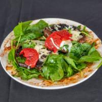 Portabella · Portabella mushroom baked on a bed of spinach and topped with melted mozzarella cheese.