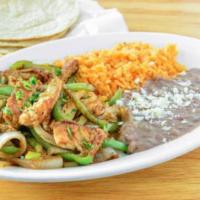 Fajitas · Your choice of chicken or steak with sauteed bell peppers and onion. Served with rice and be...
