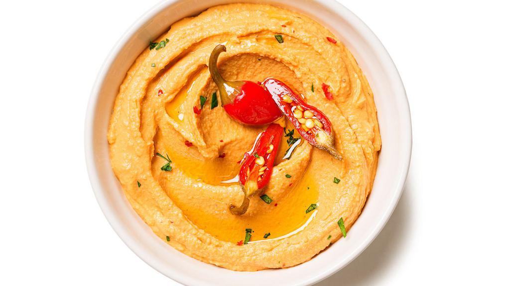 Spicy Hummus · Roasted bell peppers, aleppo pepper, nohut, with side of grilled pita bread.