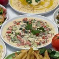 Tahini Salad · Cucumber, Tomato, Parsley Mixed with Tahini Sauce and Olive Oil Garnish with Sunflower seeds.