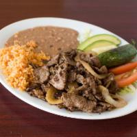 Carne Asada Rincon · Steak grilled with onions and a side of jalapenos toriados.
