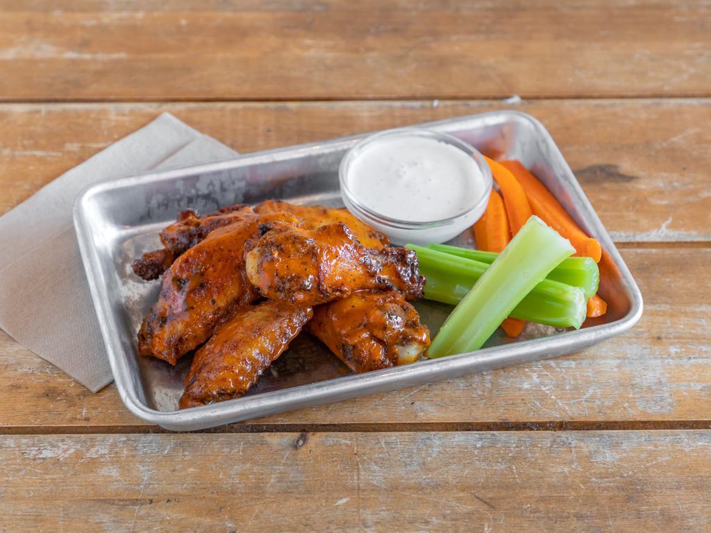 Wings · 6 wings with a choice of spicy Buffalo, BBQ, or mango habanero sauce, served with ranch dressing, sliced carrots, and celery.