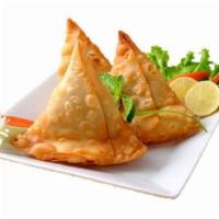 Vegetable Samosas · 2 crisp vegetable puffs filled with potatoes, peas, and spices.