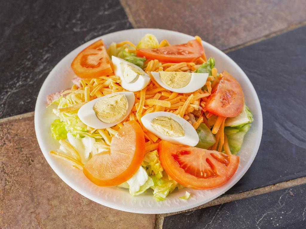 Chef Salad · Turkey, ham, cheddar cheese, hard-boiled eggs, lettuce and tomatoes.