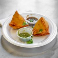 2 Piece Vegetable Samosa · Crispy pastry filled with potatoes peas and cilantro.