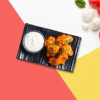 Buffalo Chicken Wings · Wings cooked and tossed in our buffalo wing sauce. Served with Blue Cheese.