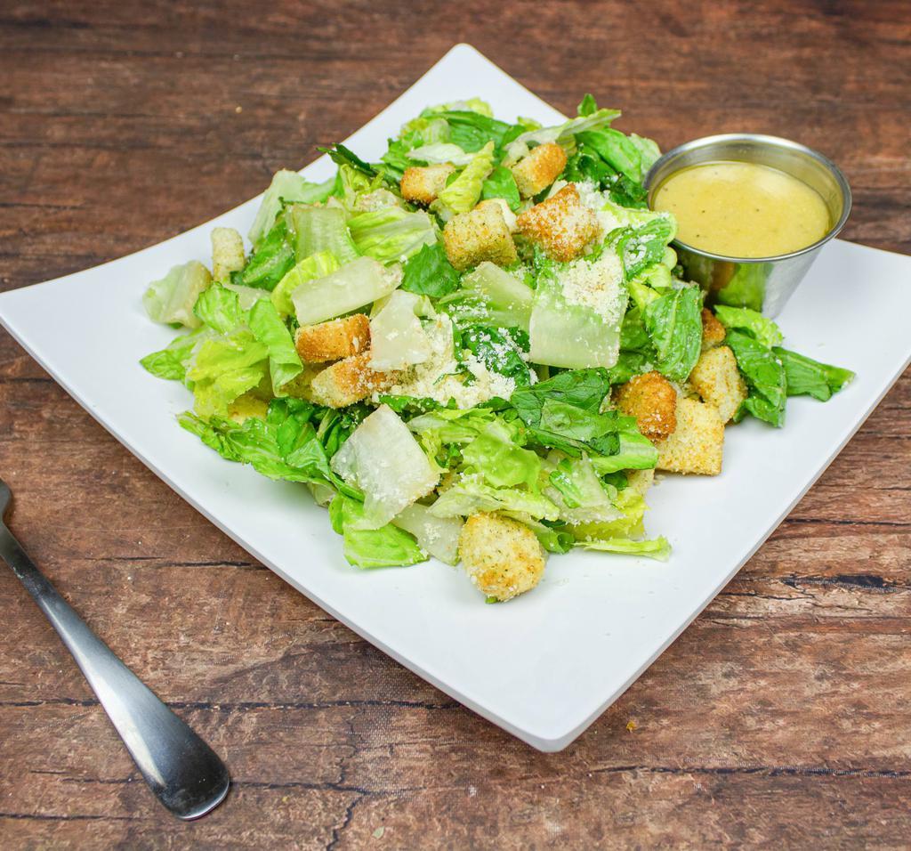 Caesar Salad · Crisp romaine lettuce with croutons and shredded Parmesan cheese. Served with our creamy Caesar dressing. (Anchovies upon request).
