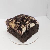 Reese's cake · Chocolate cake with peanut butter buttercream, broken Reese's and drizzled with chocolate ga...