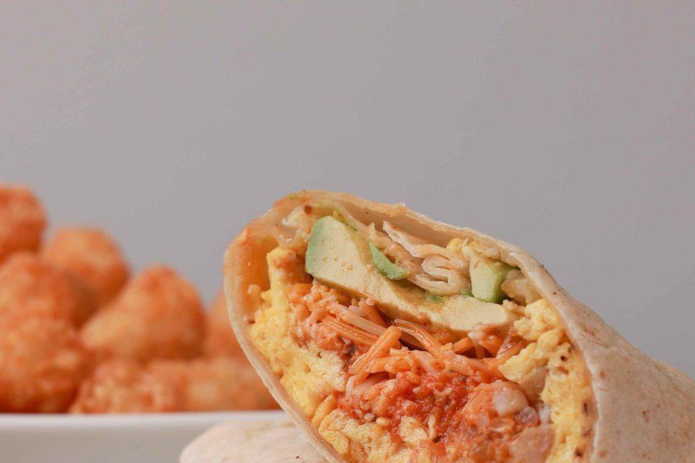 Lucky Charmer · Eggs, tater tots, ham, avocado, hot peppers, salsa roja and shredded cheddar jack cheese rolled in a flour tortilla wrap. Served with hot sauce.
