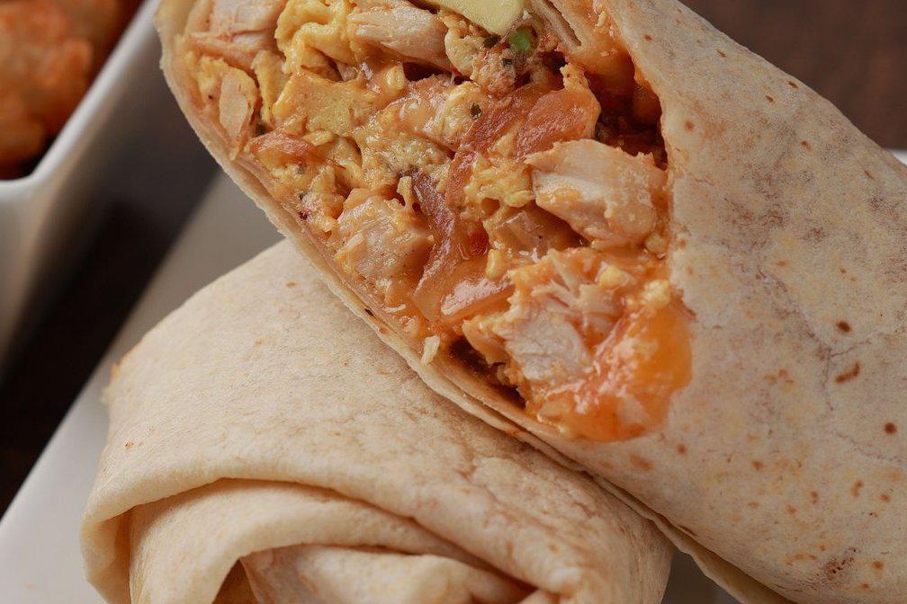 El Cherrio · Eggs, chicken, salsa roja, avocado, sauteed onions and shredded cheddar jack cheese rolled in a flour tortilla wrap. Served with hot sauce.