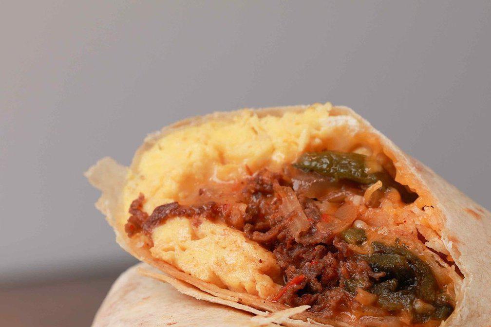 The CT Cruuunch · Eggs, ribeye steak, sauteed onions, poblano peppers, mushrooms with a spicy salsa roja and shredded cheddar jack cheese rolled in a flour tortilla wrap. Served with hot sauce. 