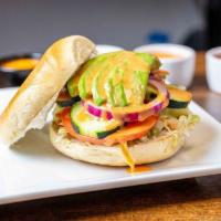 Avocado Veg Out Bagel · Lettuce, tomato, cucumber, red onions, avocado, cream cheese, and a drizzle of honey blazed ...