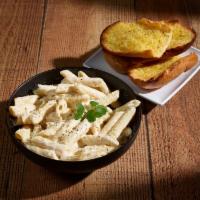 Penne Alfredo · Penne noodles covered in a creamy Alfredo sauce. Served with small garden salad and garlic b...