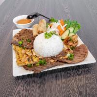 Com Dac Biet Rice Plate- Combination · Special combo. Plate of steamed rice topped with marinated grilled beef, shrimp, chicken, po...