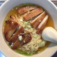 Pork Chop Noodle Soup · Egg noodles in a clear broth soup with lettuce, green onion and a grilled pork chop. 