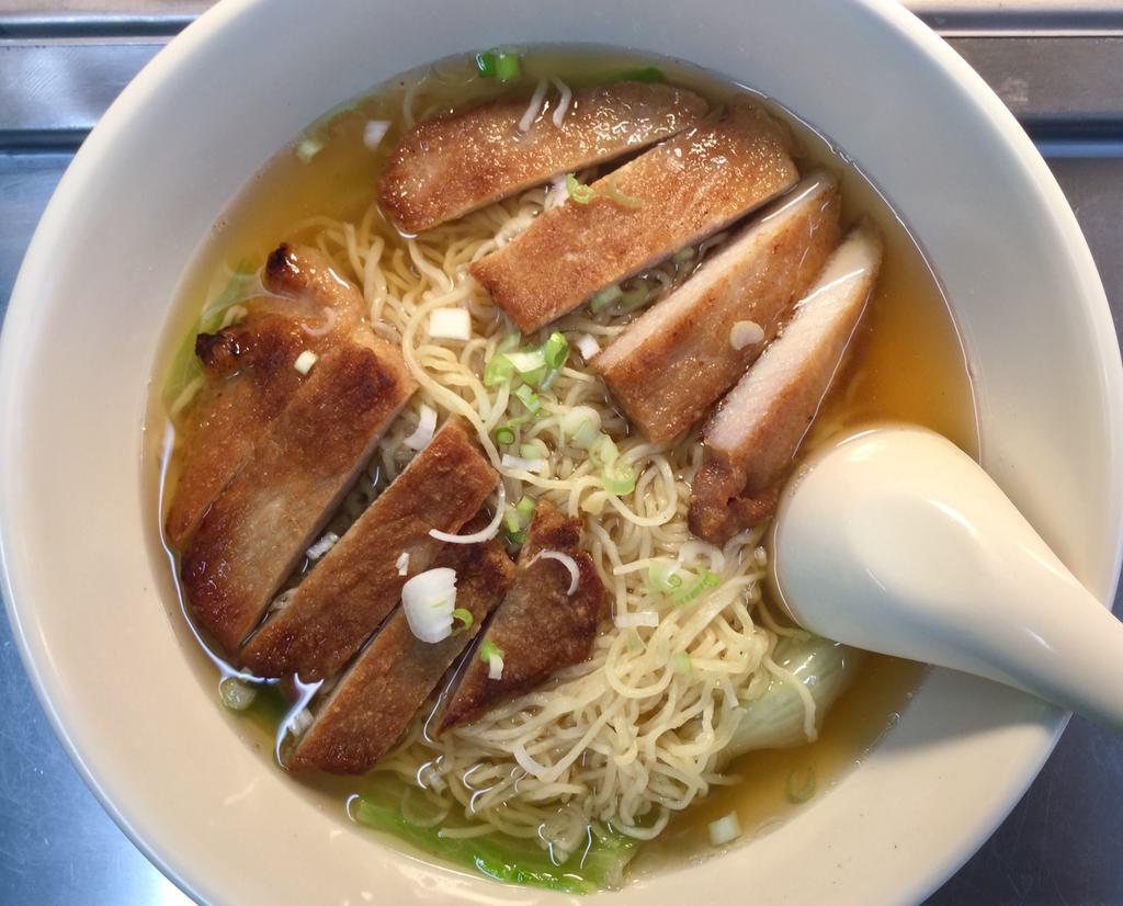 Pork Chop Noodle Soup · Egg noodles in a clear broth soup with lettuce, green onion and a grilled pork chop. 